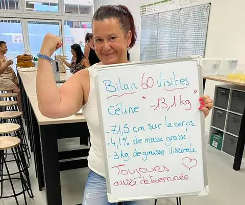 Une membre présente son bilan sur une ardoise blanche, dans la salle du club